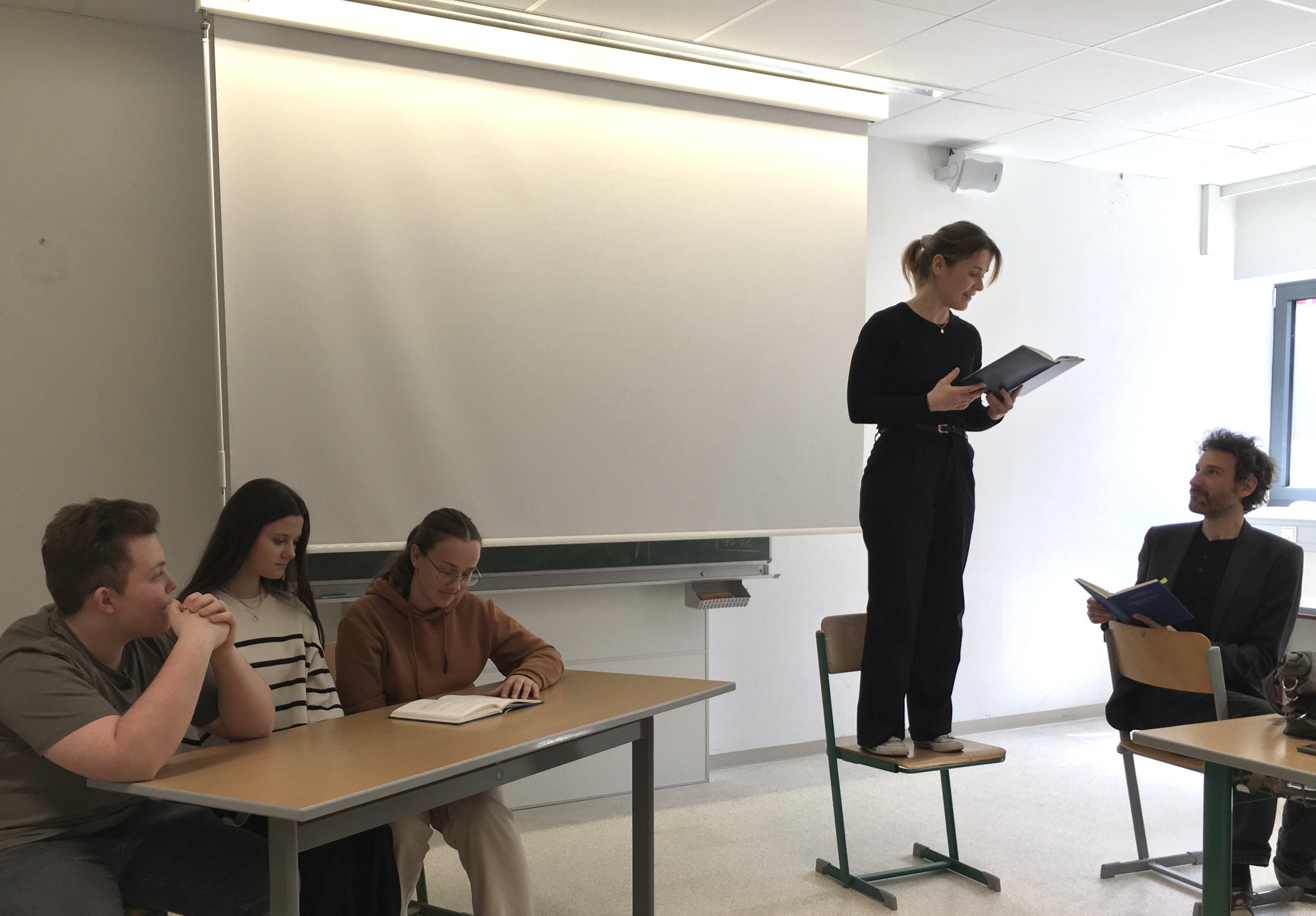 Prof. Eva Schwarzmayr und Stefan Reiser in szenischer Lesung von „Schnitzlers ‚Reigen‘ – Der nächste Tanz“. Die Regieanweisungen las Schülerin Anna, für das musikalische Zwischenspiel sorgten Leon und Luisa. Projekt „Sternlesen“, Gymnasium Schärding, am 10.04.2025. Foto: Schülerin Hannah. Abdruck/Veröffentlichung honorarfrei bei Namensnennung.